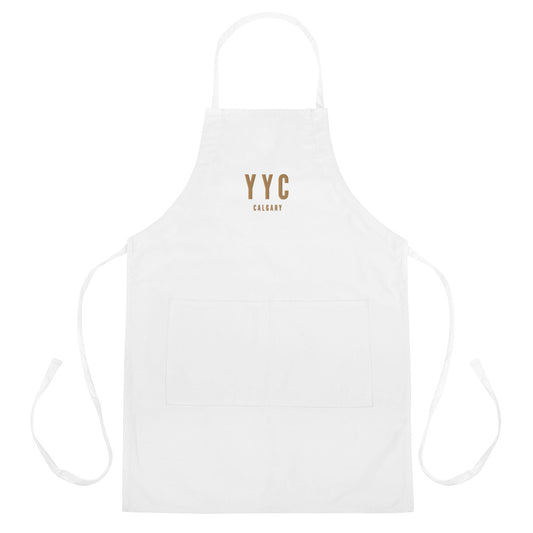 YYC Calgary Apron • Airport Code & City Name Embroidered in Old Gold • YHM Designs - Image 01