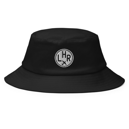 YHM Designs - LHR London Old School Cool Bucket Hat with Airport Code - Travel Gifts for Him and Her - Roundel Design with Vintage Airplane - Image 1